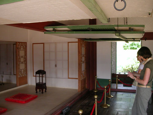 German tourists snap souvenir shots from inside Gyotaejeon, the queen's formal residence once closed to the public