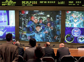 Guests and officials look at screens in the Space Mission Control Centre in Korolyov, outside Moscow, Thursday (April 10), showing a press conference of Korean astronaut Yi So-yeon (bottom), Flight Engineer Russian Oleg Kononenko (middle row, left) and Commander Russian Sergei Volkov (middle row, right) of the 17th International Space Station crew, astronaut Garrett Reisman (back row, left), ISS Commander Peggy Whitson (back row center) and Flight Engineer Yuri Malenchenko (back row, right) after the Soyuz TMA-12 spacecraft docked at the ISS. 