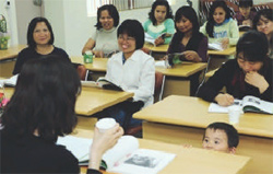 Foreigner-turned Korean wives take a Korean language class.