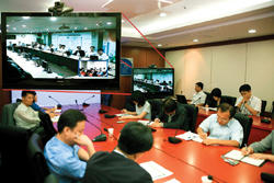 A teleconferencing session takes place in the NIA office.