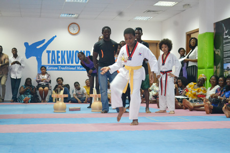 A young visitor in Taekwondo uniform engages in "jegi," a traditional game, at the Korea Cultural Center in Nigeria on Feb. 19 during a New Year cultural event.