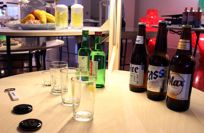 Tables laid out with bottles of beer, soju and pieces of fried chicken reflect modern people's food culture.