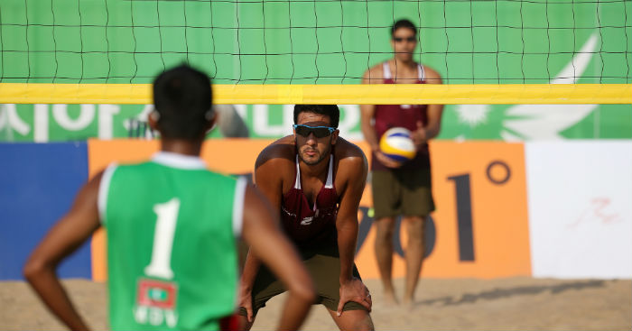 Qatar in maroon competes against the Maldives in green during the preliminary beach volleyball matches of the 17th Asian Games.