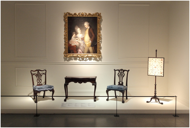 (photo) Charles Willson Peale "Portrait of John and Elizabeth Lloyd Cadwalader and Their Daughter Anne" (1772), Philadelphia Museum of Art; (table) Thomas Affleck "Card Table" (1770-1771), Philadelphia Museum of Art (image courtesy of the NMOK)