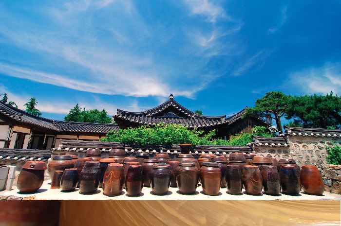 A picture of the jangdokdae, the place where a family would store its crocks and other large ceramic vessels, adjacent to a traditional home. Up until the middle of the 1970s, there was a jangdokdae in front, or on top, of each and every home. 