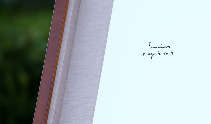 Pope Francis signs the guestbook at the birthplace of St. Andrew Kim Dae-geon.