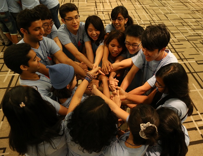 A group of teenagers participates in an ice-breaking game on August 7 during the opening ceremony.