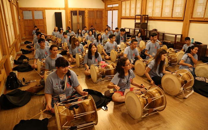 Students learn how to play the <i>janggu</i>, a traditional musical instrument, and take part in a traditional drum performance.