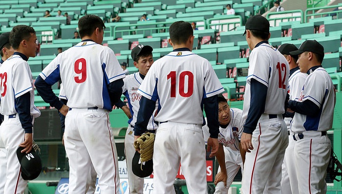 The Mongolian baseball team discusses its strategy for the next inning on September 25.