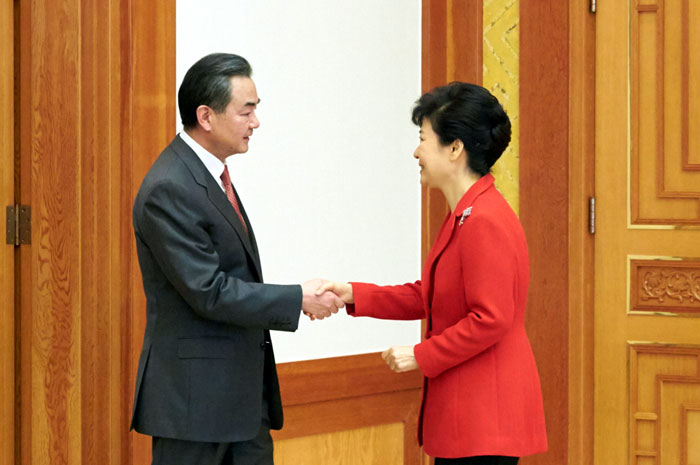 President Park Geun-hye (right) shakes hands with Chinese Minister of Foreign Affairs Wang Yi.
