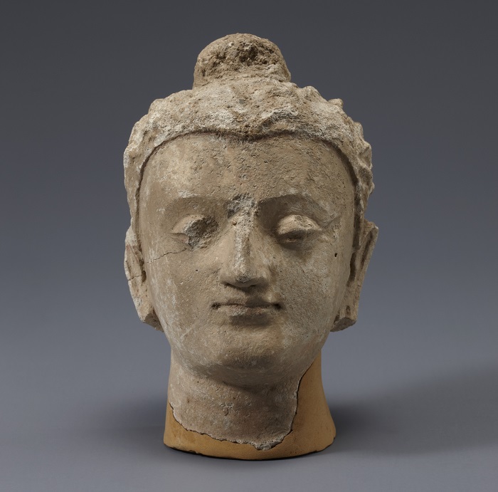 Head of Buddha. 4th century. Excavated from Afghanistan. This sculpture has elements of Hellenism which spread there between the first and second centuries.