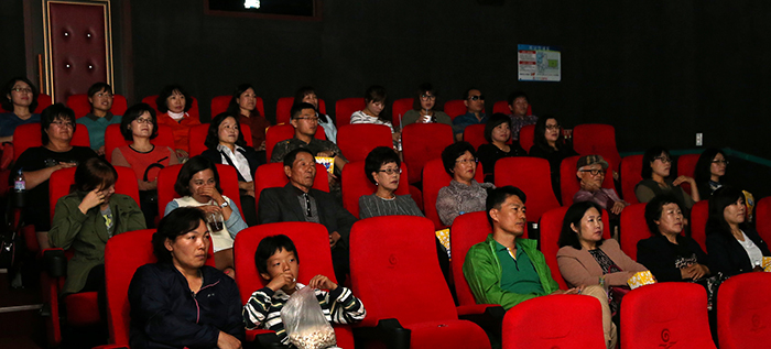 Buan residents are seen watching a movie at the Masil Cinema.