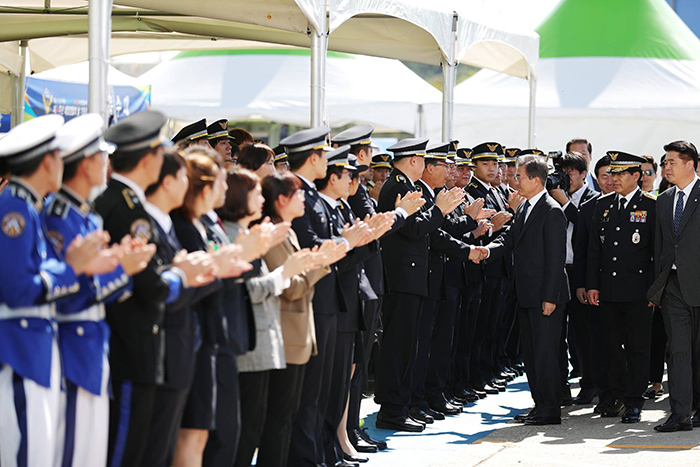 President Moon Jae-in is welcomed by members of the Korea Coast Guard as he enters the venue to mark the 64th anniversary of Korea Coast Guard Day, at the Port of Incheon Coast Guard Station on Sept. 13.