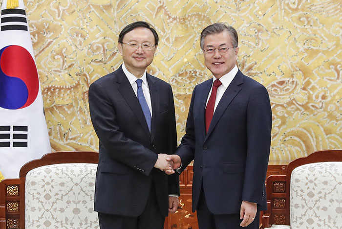 Chinese state councilor Yang Jiechi (left), a special envoy from Chinese President Xi Jinping, and President Moon Jae-in shake hands at Cheong Wa Dae on March 30.