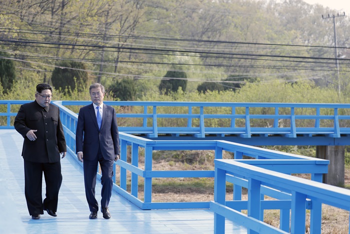 A demilitarized Joint Security Area in Panmunjom, the United Nations truce village between the two Koreas, will be opened to the public from May 1. Pictured here are President Moon Jae-in and North Korean leader Kim Jong-un on April 27, 2018, walking on a foot bridge during their summit. (Yonhap News)