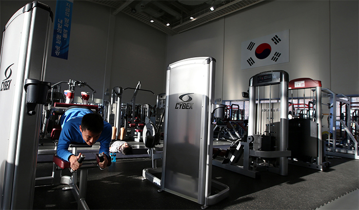 Athletes train hard for the upcoming Rio 2016 Olympics at the weight training center. 