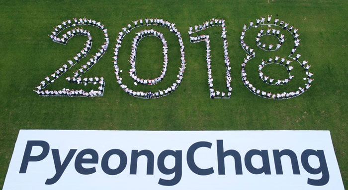 In the hope that they will successfully host the PyeongChang 2018 Olympic and Paralympic Winter Games, President Moon Jae-in, athletes and members of the organizing committee form the number 2018 at Alpensia Resort in Pyeongchang on July 24.