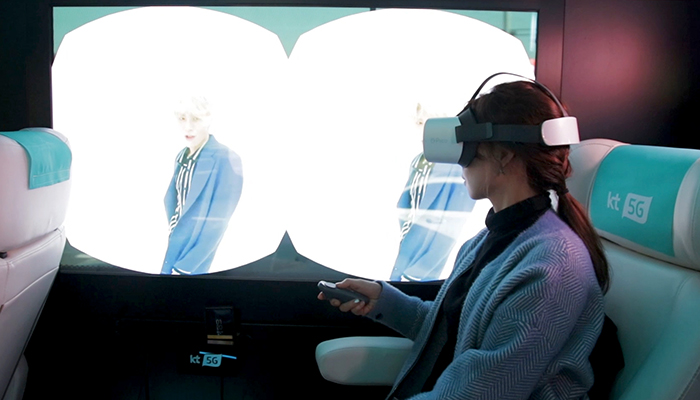 A passenger on a test ride of KT’s 5G bus tries a virtual reality (VR) head-mounted display (HMD).