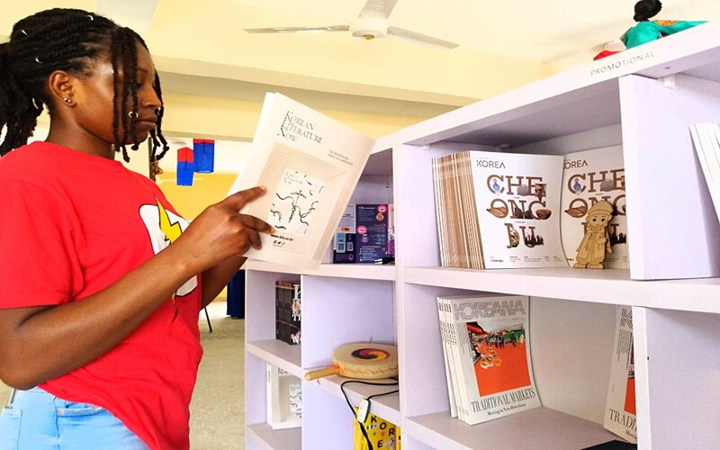 An University of Abuja student reads a book on Korean literature at the school's Korean Corner. 