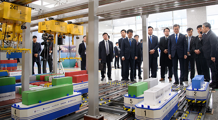 President Moon Jae-in inspects a replica of an automated container terminal, at Busan New Port on March 16.