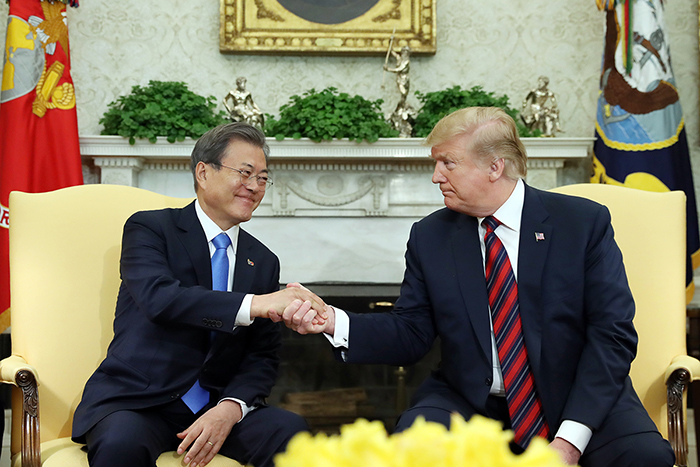 President Moon Jae-in and U.S. President Donald Trump on April 11 shake hands at the White House in Washington during their last summit. Both leaders will hold another summit in Seoul in June. (Cheong Wa Dae)