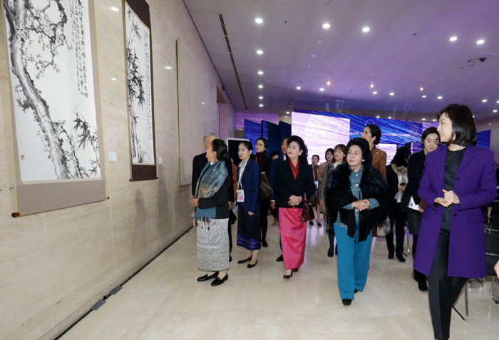 The ASEAN first ladies appraise the works of art on display at a special exhibition underway at the Busan Cinema Center in Busan on December 12. 