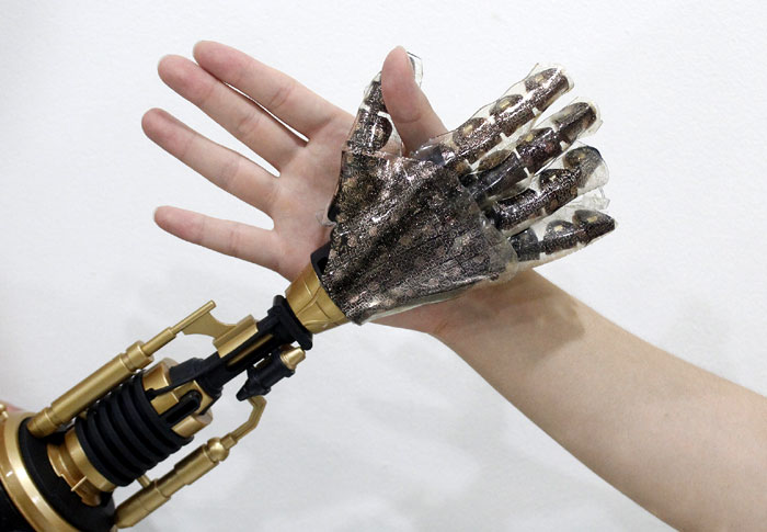 The above photo shows an artificial hand made with the artificial skin next to a human hand.