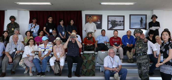 The travel group comprising foreign diplomats and correspondents visits the Cheonan 46 Warriors Memorial Tower, where they hear from Jo Dong-taek, head of the 6th Marine Brigade, on the region’s historical background (photo: Jeon Han).