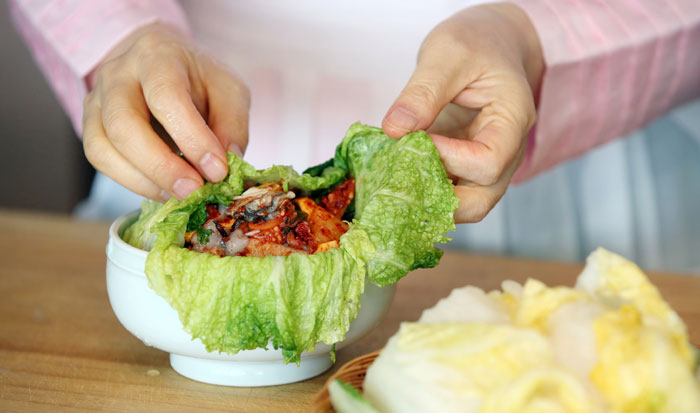 Seafood and other ingredients are placed in a bowl laced with three or four cabbage leaves. It is then wrapped up tightly.