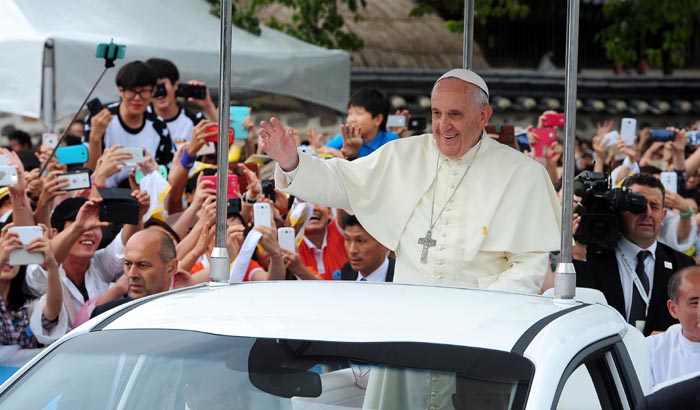 Pope Francis enters the Haemi Fortress in a white open-topped car, in Seosan, Chungcheongnam-do, on August 17, to celebrate the closing Mass of the sixth Asian Youth Day. 
