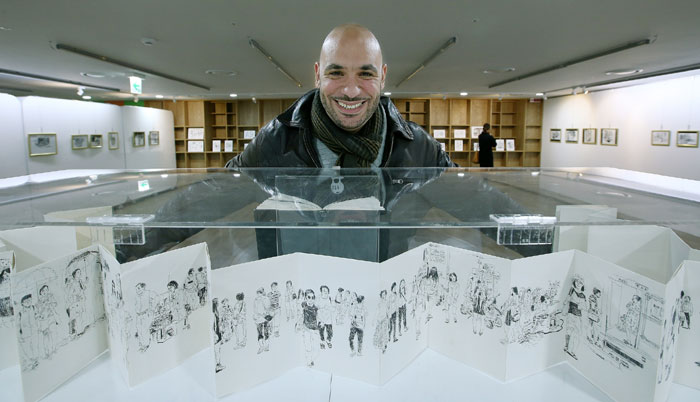 Illustrator Samir Dahmani poses for a photo at his exhibition in the Seoul Metropolitan Library.