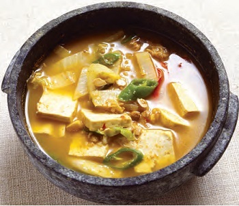 <i>Doenjang Jjigae</i> (Soybean Paste Stew). This stew-like Korean dish is made by boiling an assortment of ingredients such as meat, clams, vegetables, mushrooms, chili, tofu, and soy paste.