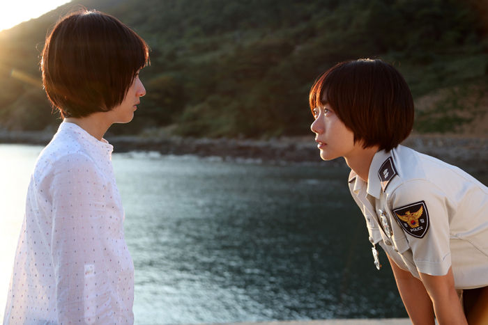  In a scene from 'A Girl at My Door,' Young-nam, played by Bae Doona (right), asks Do-hee, portrayed by Kim Sae-ron, to go with her. 