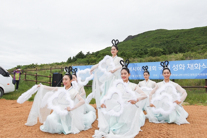 Students from Gwangju Arts High School dress as seven heavenly maidens before the torch for the Gwangju Summer Universiade Games is ignited at the Jangbuljae mountain pass at Mudeungsan National Park.