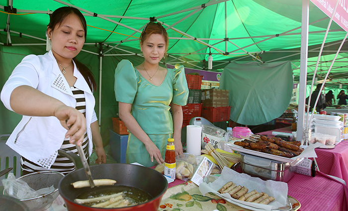 Two volunteers cook lumpia, a traditional Philippine fried egg roll, at a food stall, part of the Gwangjang Festival held in Gwangju on October 17. 