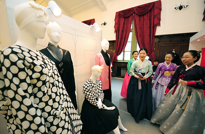 Hanbok wearers look at new Hanbok designs on display during Hanbok Day.