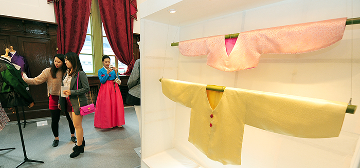 People look around the Hanbok on display during the Hanbok Day events.