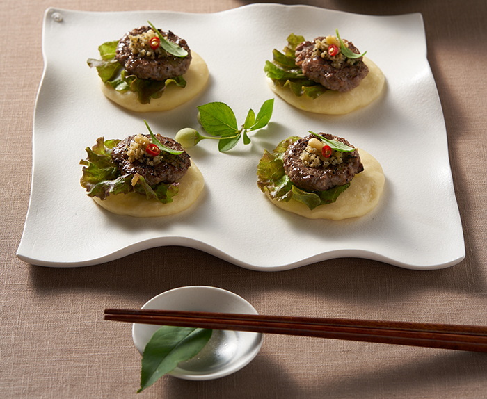 Modern <i>Bulgogi</i> is a dish of roasted beef patties served with bread and a fresh salad.