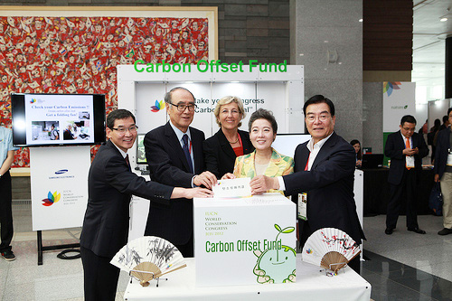 Minister of Environment Yoo Young-sook (second from right), IUCN Director General Julia Marton-Lefèvre (third from right), and Chairman of the Korean Organizing Committee for the 2012 WCC Lee Hong-koo (second from left) pose together in front of the Carbon Offset Desk at the 2012 World Conservation Congress exhibiton area, where visitors can make voluntary contributions to offset their carbon footprints (photo courtesy of IUCN).