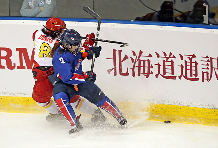Korea’s Park Jong-ah (right) controls the puck, keeping it from a Chinese skater, during the women's tournament round robin ice hockey match in the Tsukisamu Gymnasium at the Asian Winter Games in Sapporo, Japan, on Feb. 23. Park scored the third goal, which brought victory to the Korean team.