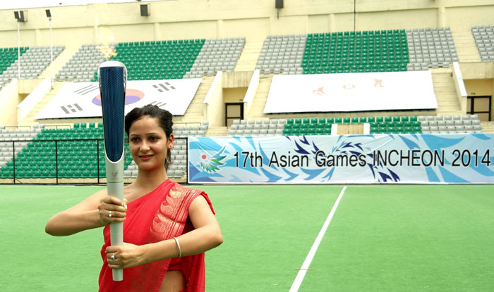 The torch for the Incheon Asian Games 2014 is held aloft in New Delhi. A concave mirror was used to light the torch. (photo courtesy of the IAGOC)