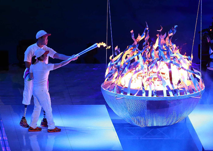 Swimmer Kim Sejin and his mother light the flame during the opening ceremony of the Incheon Asian Para Games 2014.