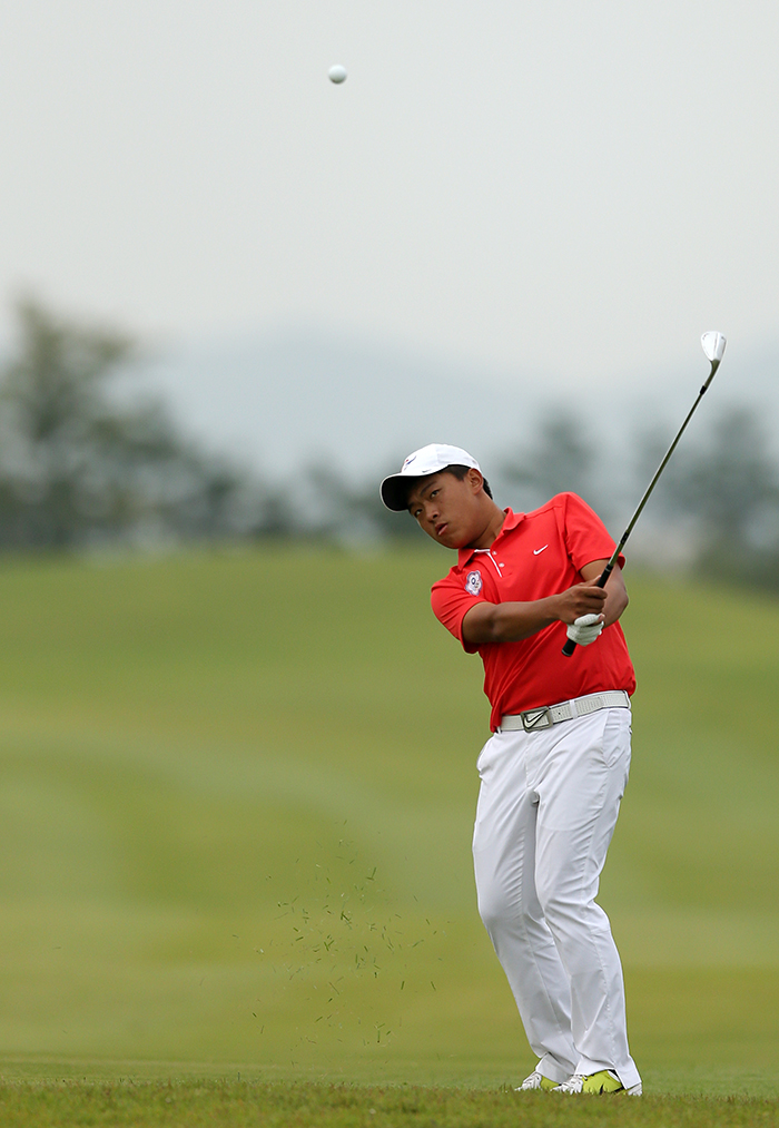 Taiwanese golfer Pan Cheng Tsung follows his ball after hitting an approach shot on the 16th hole during the fourth round at the Asian Games in Incheon on September 28. 
