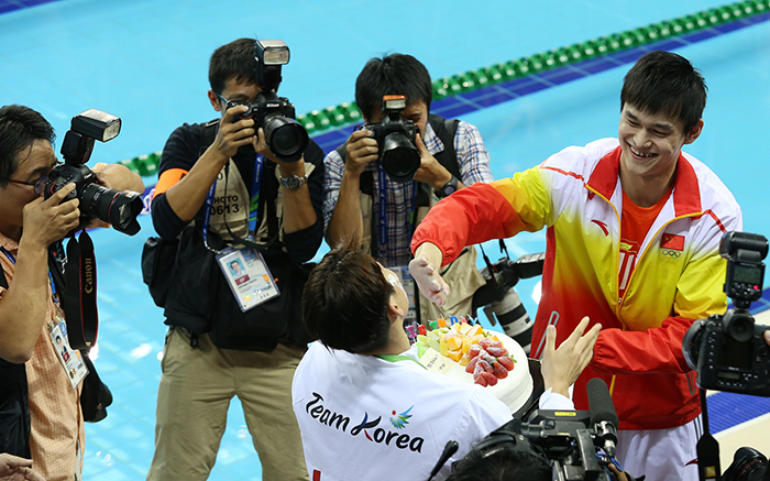 Sun Yang (right) smiles as he smears Park Tae-hwan with whipped cream from Park's birthday cake on September 26, a day before Park’s birthday.