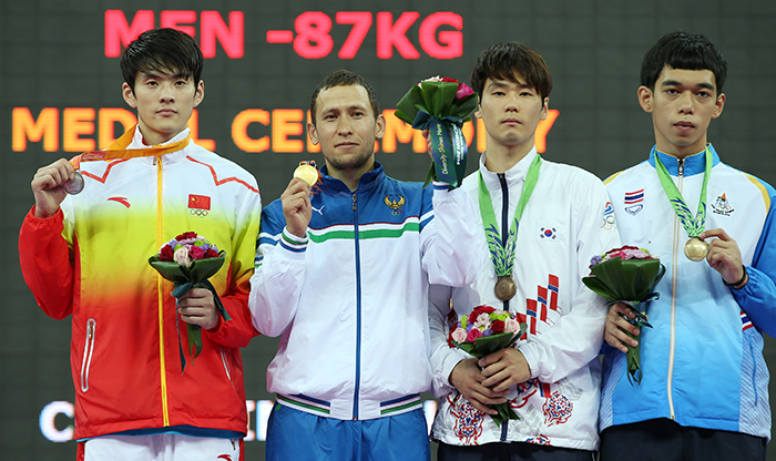 Medalists in the men’s taekwondo 87 kilogram event pose for a photo on the podium after the award ceremony on September 30 at the Incheon Asian Games 2014.