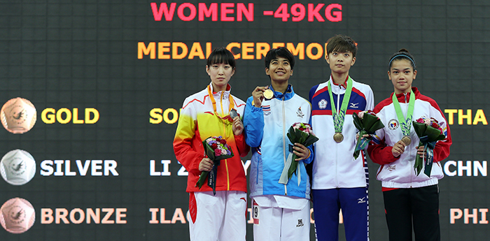 Medalists in the women’s taekwondo 49 kilogram category are on the podium after the award ceremony on September 30 at the Incheon Asian Games.