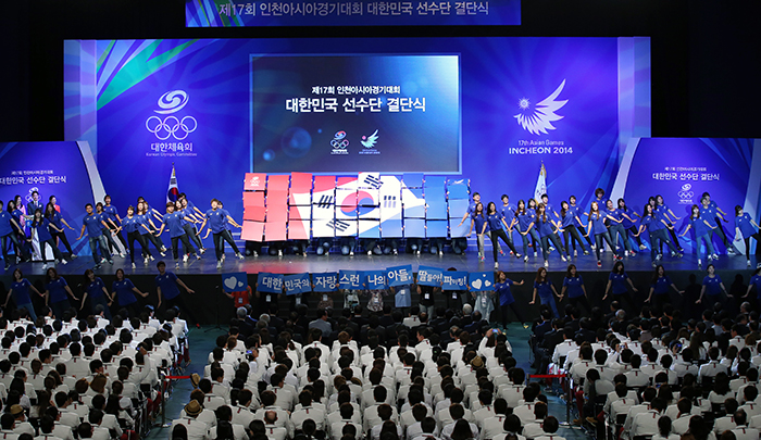 Supporters and parents of the athletes get on stage to cheer up the sports stars during the launch ceremony for Team Korea on September 11.