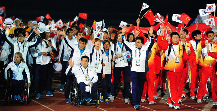 Athletes from South Korea and China enter the venue for the closing ceremony of the Incheon Para Asian Games 2014.