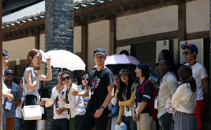 Participants in the “Exploring UNESCO World Heritage in Korea” program listen as tour guide Lee Byeong-yoo explains about the royal tomb and its resident, the "Boy King" Danjong, the sixth monarch of the Joseon Dynasty, on May 31. (photo: Jeon Han)