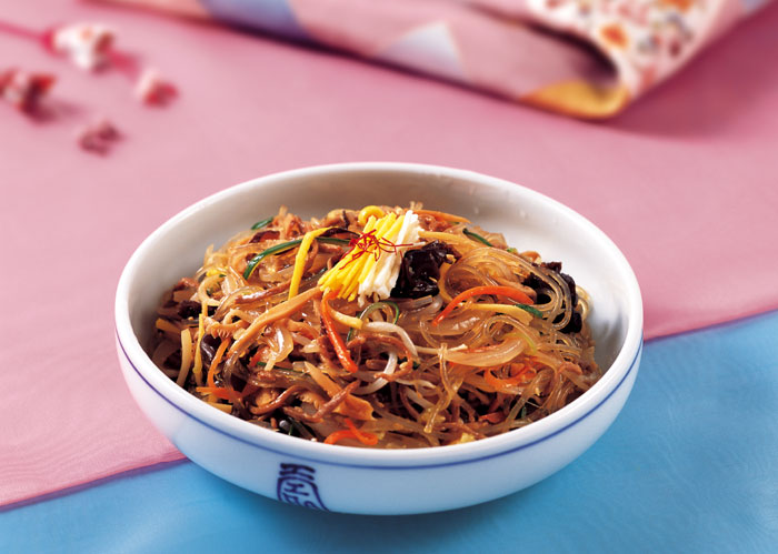 <i>Japchae</i> is made from various vegetables and meat all stir-fried together with potato starch noodles.